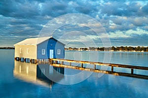 Rustic blue house on the water