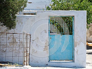 Rustic Blue Metal Door in Whitewashed Wall