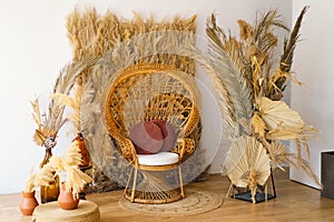 Rustic Bohemian Interior Design With Rattan Peacock Chair and Pampas Grass Decor