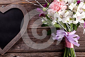 Rustic bouquet from gillyflowers and alstroemeria on old wooden