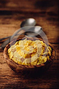 Rustic bowl of corn flakes with spoons