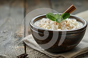 Rustic Bowl of Creamy Rice Pudding with Cinnamon and Mint