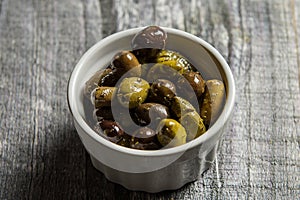 Rustic bowl of mixed olives on wood