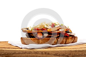 A rustic bread brusquette with mayonnaise, bacon, mushrooms and vinaigrette, drizzled with EVOO or olive oil. Typical Spanish tapa photo