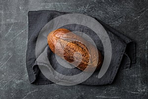 Rustic bread on dark background. Flat lay