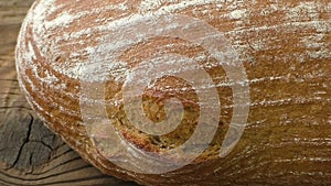 Rustic bread on an old vintage planked wood table. Freshly baked bread in rustic setting on wooden background