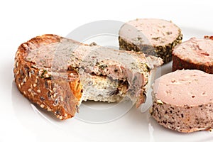 Rustic bread spread with pate, bite missing.