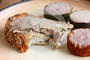 Rustic bread spread with pate, bite missing.