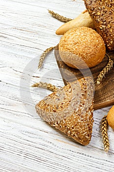 Rustic bread and wheat on an old vintage planked wood table. free text space