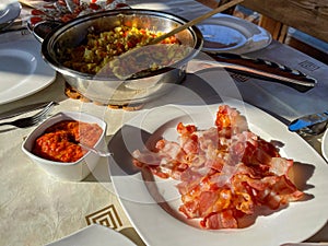 Rustic breakfast at the campsite for several tourists