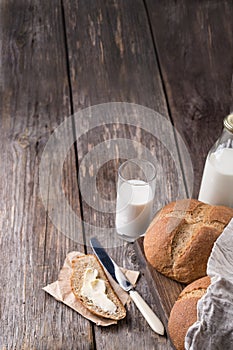 Rustic breakfast with wholegrain bread, milk and butter