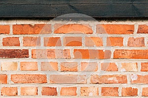 Rustic brick wall with old wooden joist as background