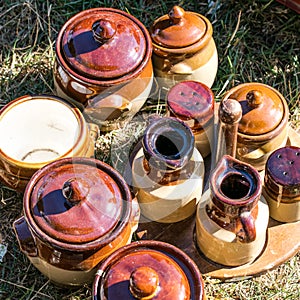 Rustic brown potteries and condiment container set at garage sale photo