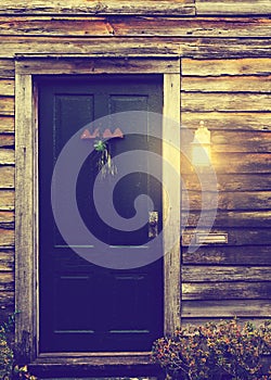 Rustic cabin door with porch light