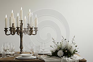 A rustic candlelit dinner setting featuring an antique wooden table set against a stark white background