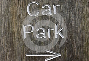 Rustic car park directional sign with arrow