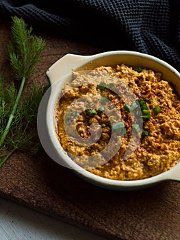 Rustic carrot hummus on wooden board