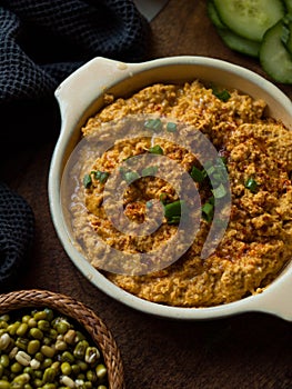 Rustic carrot hummus on wooden board