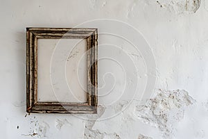 The rustic charm of an aged wooden picture frame hanging on a bare white wall