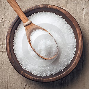 Rustic charm Coarse grained salt in a wooden bowl on oak