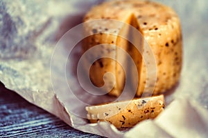 Rustic cheese with herbs on paper background