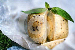 Rustic cheese with herbs on paper background