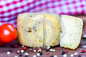 Rustic cheese with herbs, pepper and tomatoes