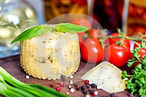 Rustic cheese with herbs, pepper and vegetables