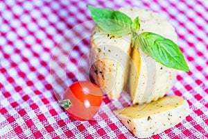 Rustic cheese with herbs and tomatoes