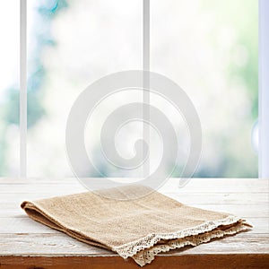Rustic Chic: Wooden Table with a Napkin in Perspective. Canvas napkin with lace, tablecloth on wooden table on a sunny