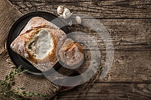 Rustic chicken soup with mushrooms in bread with spices on rustic wooden background. Healthy food concept, top view, flat lay,