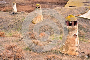 Rustic chimneys of cave houses photo