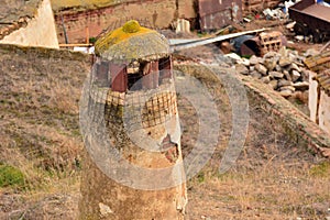 Rustic chimneys of cave houses photo