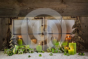 Rustic christmas decoration in green colors with presents and ca