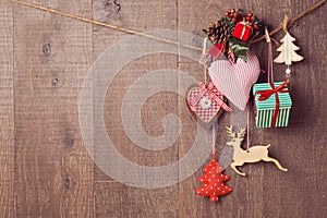 Rustic Christmas decorations hanging over wooden background with copy space photo