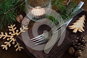 Rustic Christmas table setting with candle.