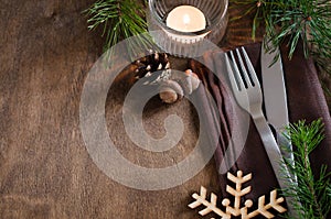 Rustic Christmas table setting with candle.