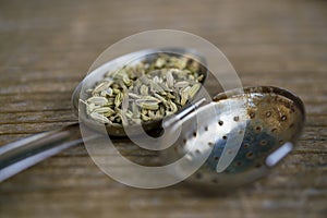 Rustic close up of fennel tea seeds in strainer