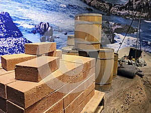 Rustic Coastal Construction Bricks and Barrels with Rocky Shoreline Perspective photo