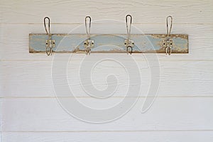 Rustic coat hooks background on white weatherboard house