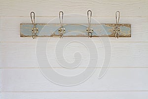 Rustic coat hooks background on white weatherboard house photo