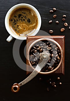 Rustic coffee mill and cup of coffee