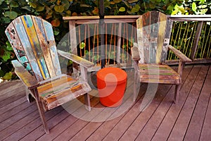 Rustic and Colorful Adirondack Chairs on Wood Deck