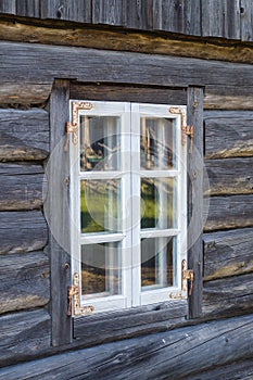 Rustic cottage window in old wooden rural house