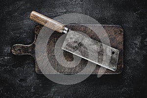 Rustic Cutting Board and Meat Cleaver on Dark Background