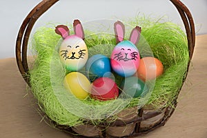 Rustic easter basket with colorful eggs and handcraftet floral h