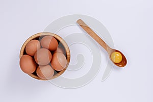 Rustic eggs close-up in a plate, one egg in a spoon. White background. Isolate