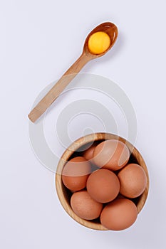 Rustic eggs close-up in a plate, one egg in a spoon. White background. Isolate