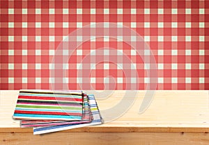 Rustic empty wooden table with tablecloth and retro background. Ready for product display montages