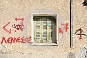 Rustic Faded Green Shutters with Red Graffiti